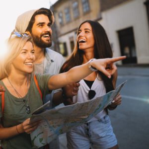 Happy friends enjoying sightseeing tour in the city